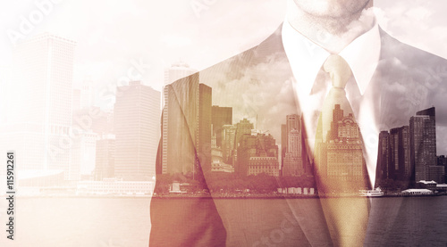 Businessman standing at cityscape background