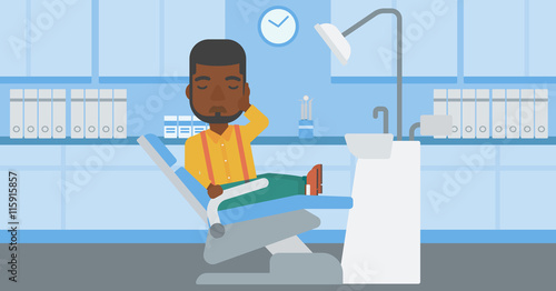 Man suffering in dental chair.