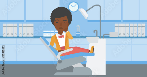 Woman suffering in dental chair.