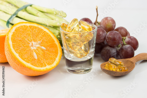Fototapeta Naklejka Na Ścianę i Meble -  Vitamin Capsules with fruit on white