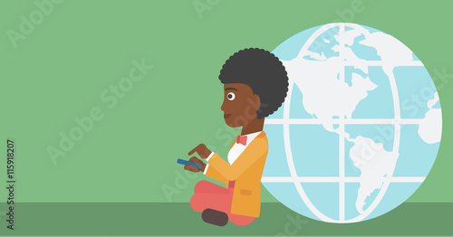 Businessman sitting near Earth globe.