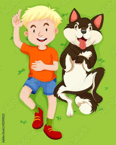 Boy and pet dog on grass