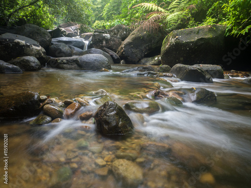 Waterfall in a lush rainforest. Photographed at the Khao Cha Mao Falls in the National Park in Rayong. Thailand