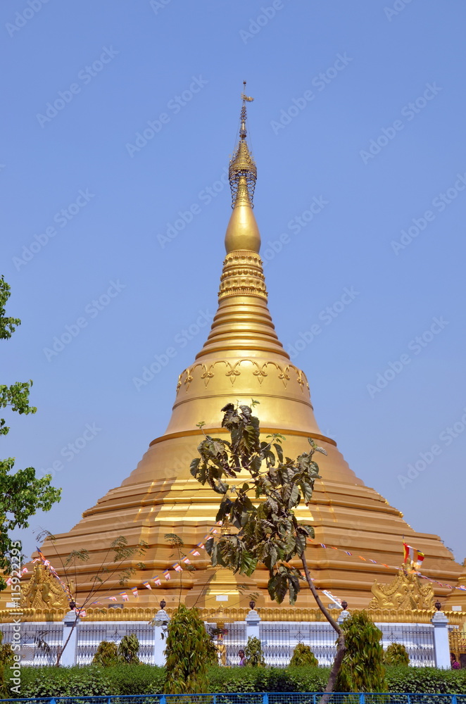 Fototapeta premium Huge golden buddhist stipa in Kushinagar, India. It is important Buddhist pilgrimage site, where Buddhists believe Gautama Buddha attained Parinirvana after his death