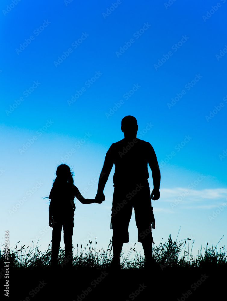 silhouette father and daughter holding hands at sunset