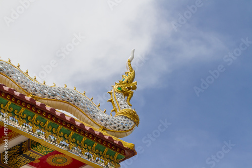 Traditional Thai style naga art on the roof in temple photo