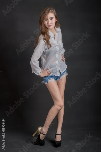 Portrait of model beautiful girls wearing White shirt and short jeans in clean skin beautiful and smart concept with Black .fabric background