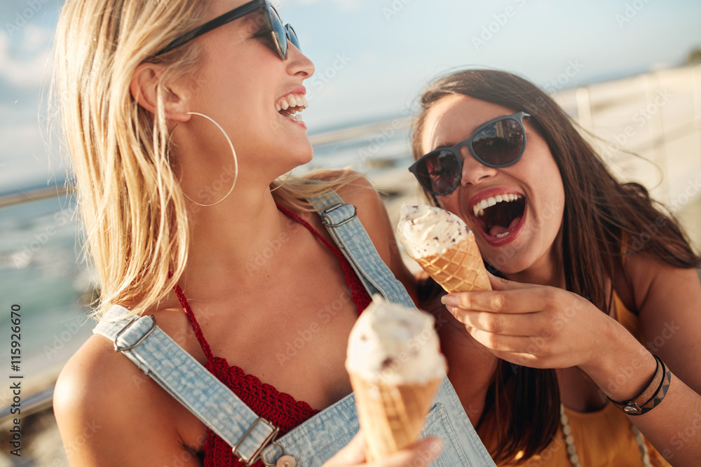© Jacob Lund - Two best friends having ice cream together outdoors