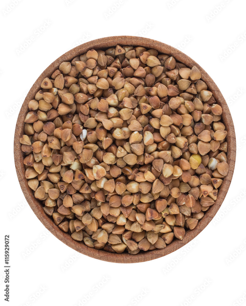 Buckwheat seeds in a wooden bowl close up isolated on white background Buckwheat seeds in a wooden bowl close up isolated on white background