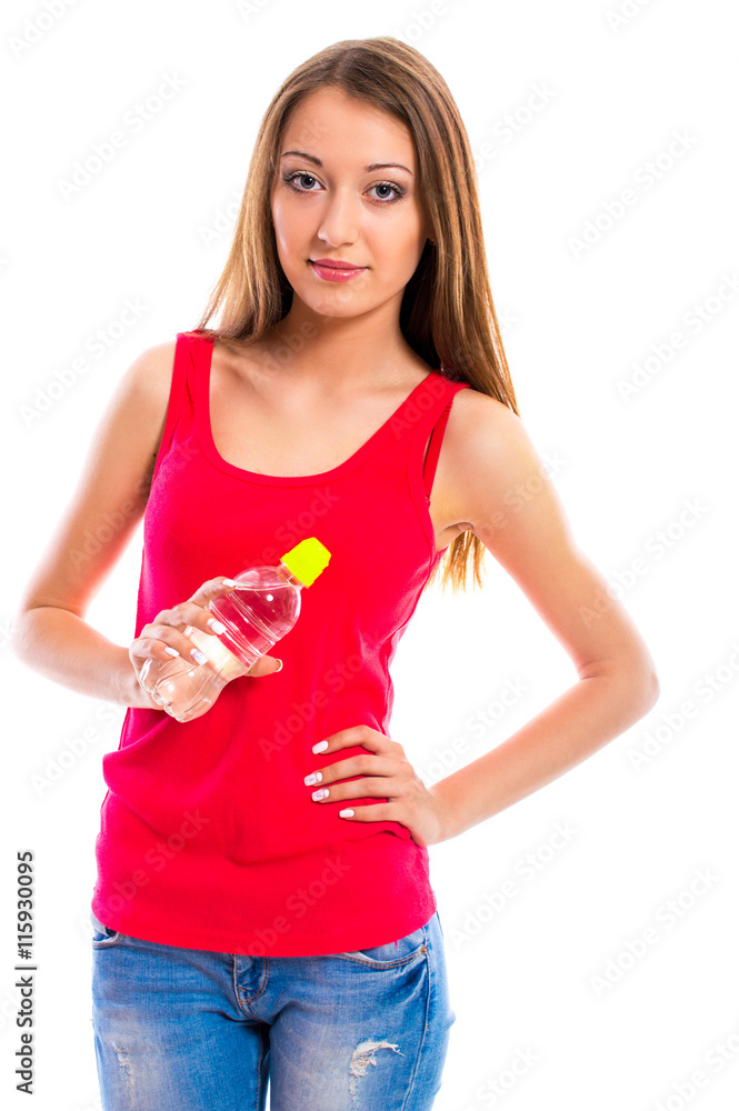 Young attractive woman in blue jeans with a bottle of water isolated on a white background. Beautiful girl model posing in the studio. Space for text. Young attractive woman in blue jeans with a bottle of water isolated on a white background. Beautiful girl model posing in the studio. Space for text.