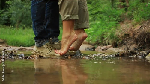 A young loving couple hugging and kissing. Two lovers, man and woman barefoot near the water.