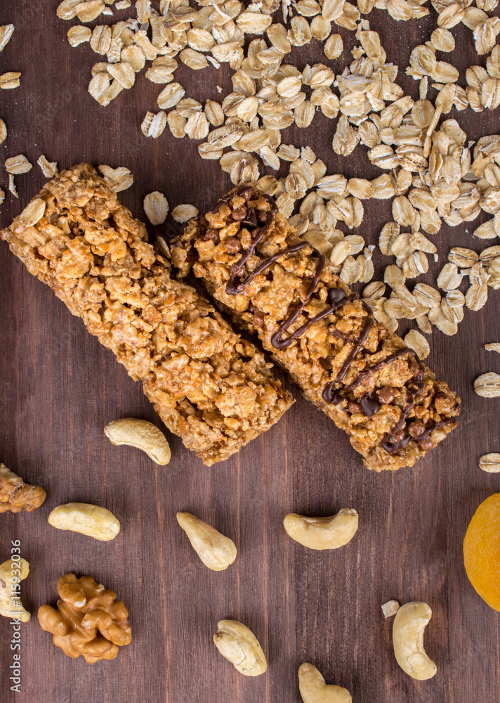 Fitness workout meals: cereal bars, oatmeal, nuts, grains, fruits on the wooden table. Fitness workout meals: cereal bars, oatmeal, nuts, grains, fruits on the wooden table.