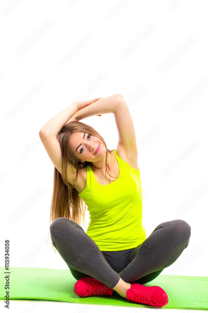 Young smiling woman in sportswear doing yoga stretching, isolated on white background.