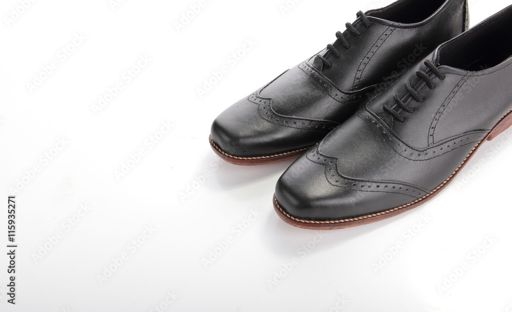 Shiny black leather shoes on white copyspace Shiny black leather shoes on white copyspace