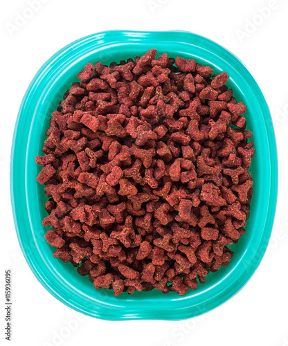 Blue plastic bowl with dry food for the animals. Plate for eating cats and dogs isolated on a white background