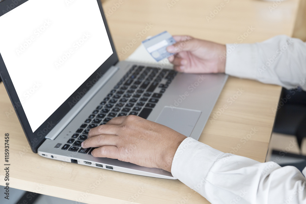businessman's hand with laptop computer and credit card for paym businessman's hand with laptop computer and credit card for paym