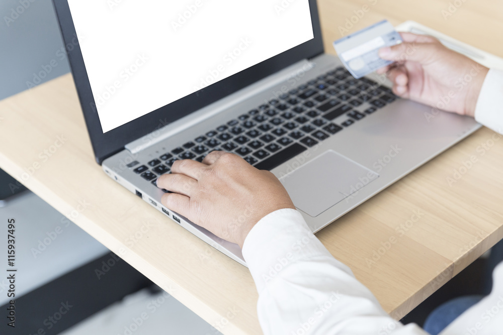 businessman's hand with laptop computer and credit card for paym businessman's hand with laptop computer and credit card for paym