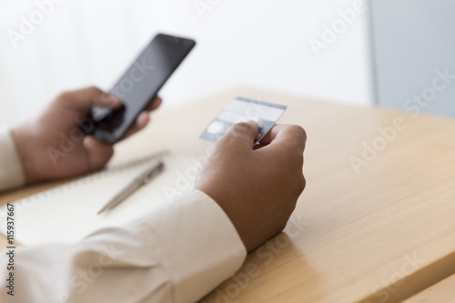 businessman's hand with mobile phone and credit card for shoppin