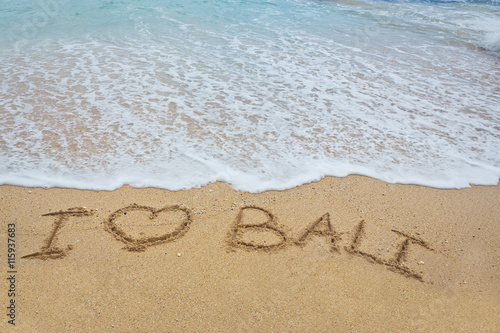 Inscription "I love Bali" writing on the sand
