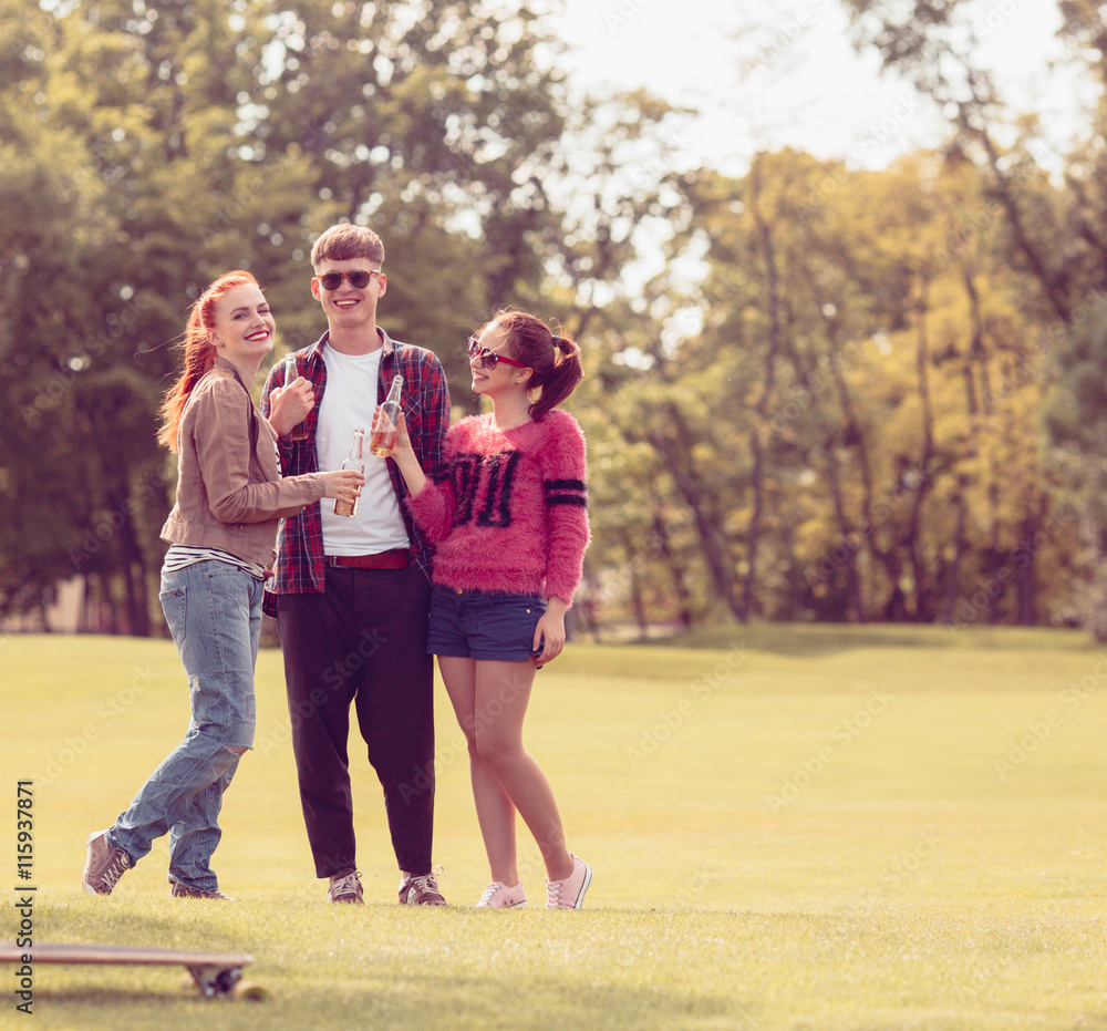 Best friends in glasses resting and relaxing in park. Closeup picture of people posing in full length while spending time in park. Best friends in glasses resting and relaxing in park. Closeup picture of people posing in full length while spending time in park.