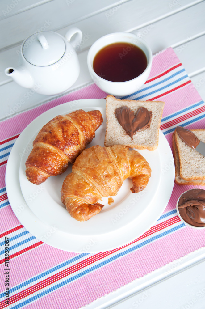 Sunday breakfast. Croissants with tea and peanut butter.