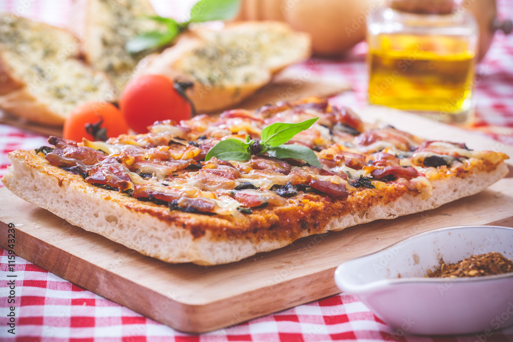 Homemade bacon pizza with garlic bread