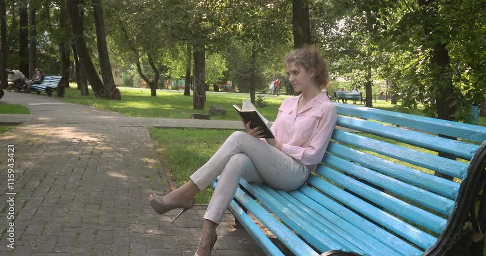 Girl with the book on a park bench Girl with the book on a park bench
