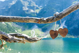 Two wooden heart on the background of the Mountain Lake Morskie Oko in the High Tatras 