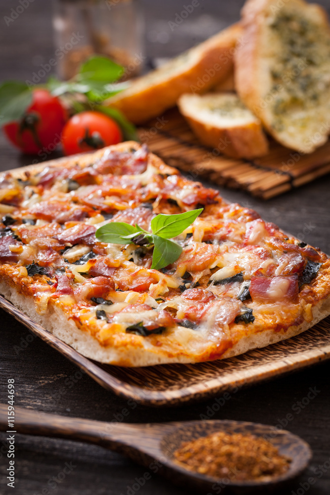 Homemade bacon pizza with garlic bread