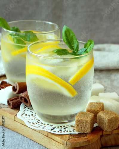 Glasses with cold lemonade and ice cubes..