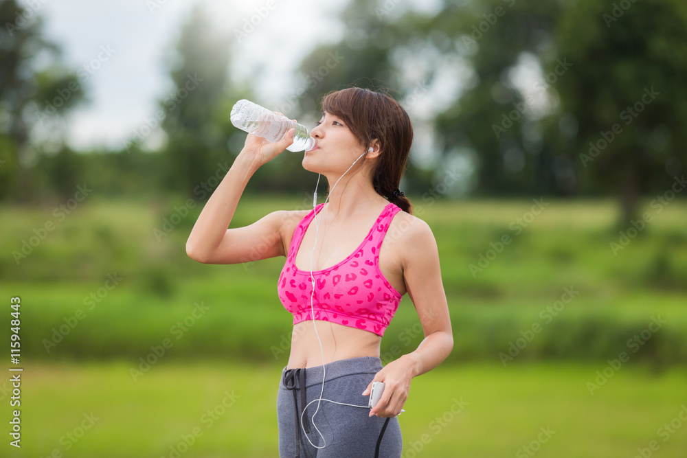 Girl drinking water while exercising with thirst. Girl drinking water while exercising with thirst.