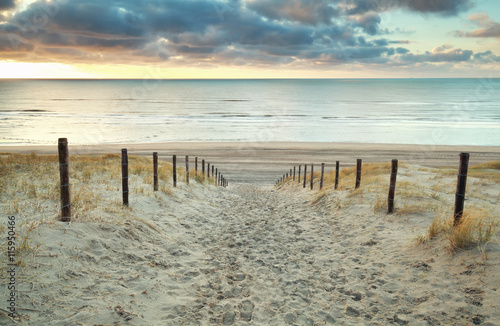 sand path to the North sea at sunset