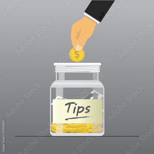 Hand dropping a coin into tips box