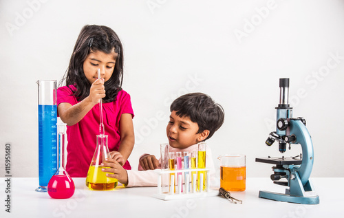 4 year old indian boy and girl doing science experiment, science Education. asian kids and science experiments, chemistry experiment, indian kids and science experiments, indian kids and science lab photo