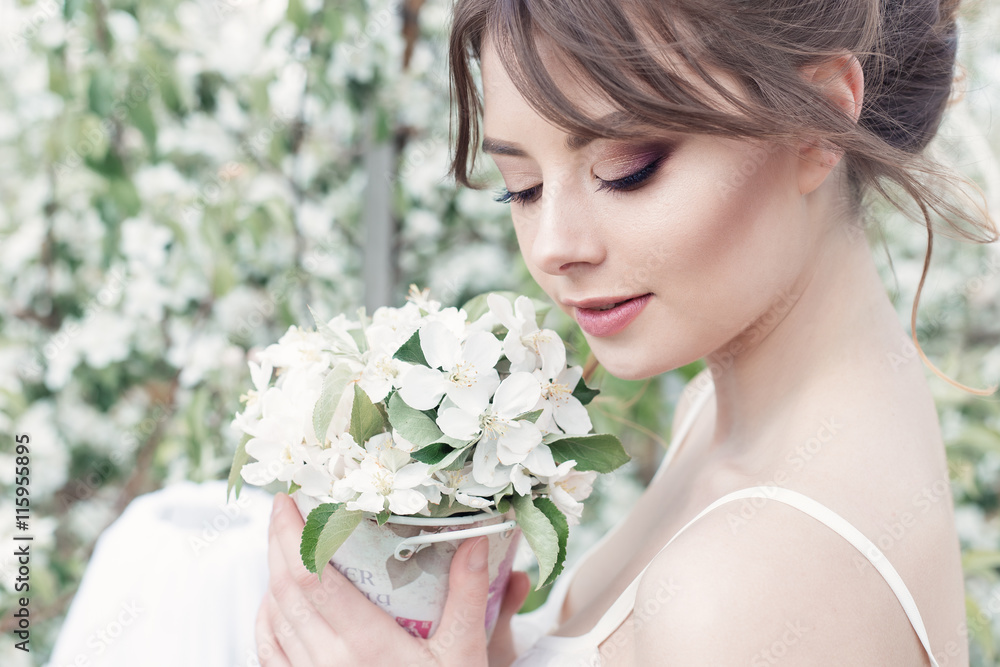 portrait of a beautiful sexy cute girl bride in a white dress with delicate make-up and hairstyle of the evening with a bunch of delicate flowers garden portrait of a beautiful sexy cute girl bride in a white dress with delicate make-up and hairstyle of the evening with a bunch of delicate flowers garden