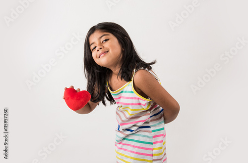 small girl with heart, indian girl holding heart, asian girl with heart, 4 year old girl with red heart toy photo