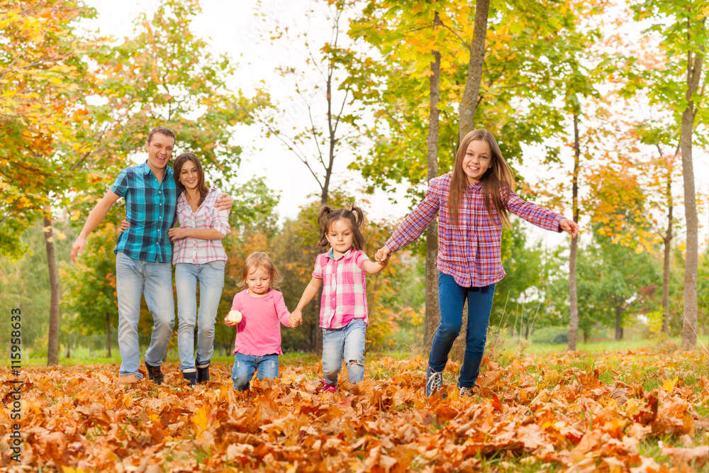 Parents walk in the park with little girls Parents walk in the park with little girls