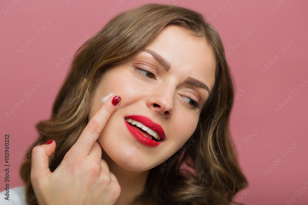 Beautiful woman with a face moisturizer Beautiful woman with a face moisturizer