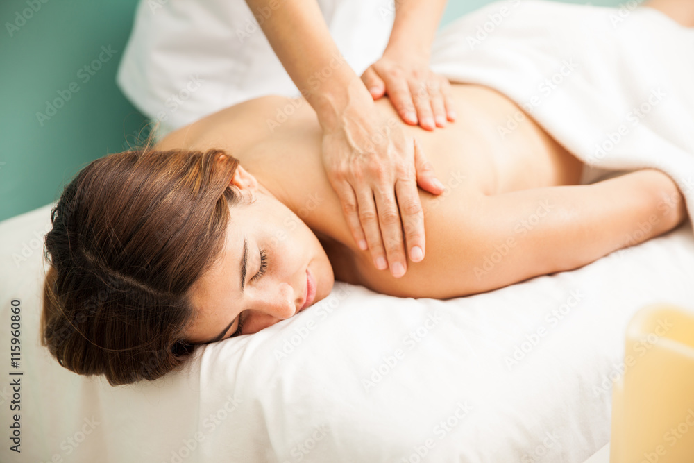 Caucasian woman getting pampered with a relaxing massage at a spa Caucasian woman getting pampered with a relaxing massage at a spa