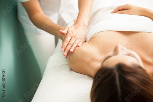 Woman getting an arm massage at a spa photo