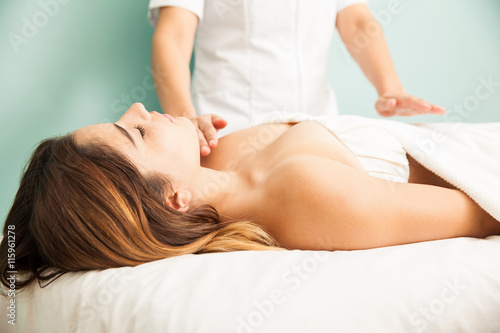 Woman in the middle of a reiki therapy session