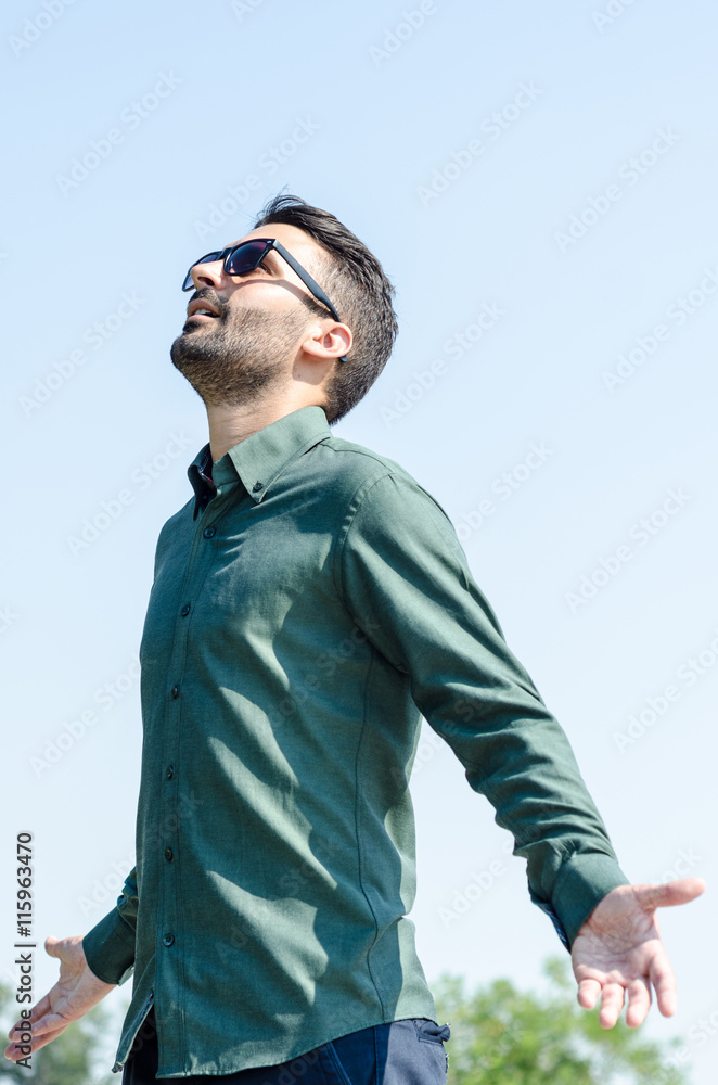 businessman spreading his arms, looking at the sky and feel the businessman spreading his arms, looking at the sky and feel the