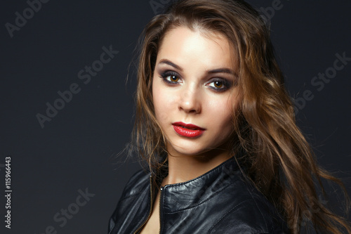 Portrait of beautiful brunette female wearing leather jacket