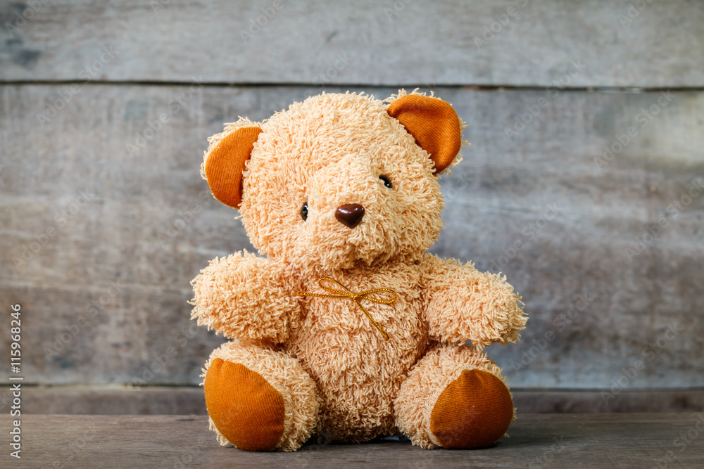 Obraz premium Cute teddy bears sitting on old wood background