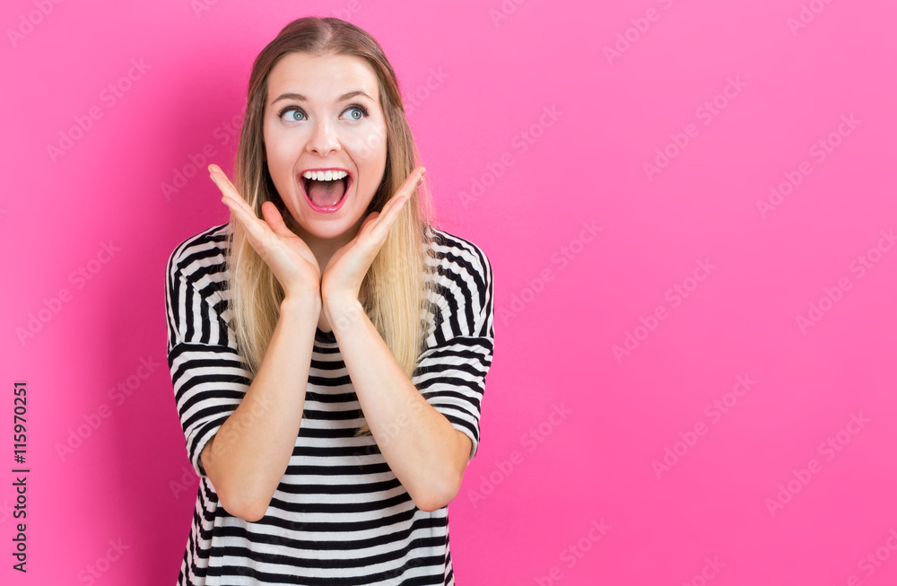 Happy young woman posing on pink background Happy young woman posing on pink background