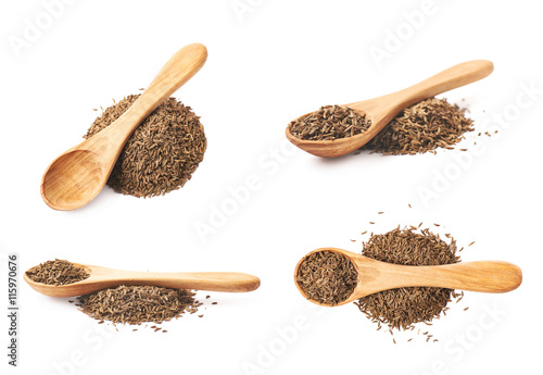 Wooden spoon over the pile of cumin photo