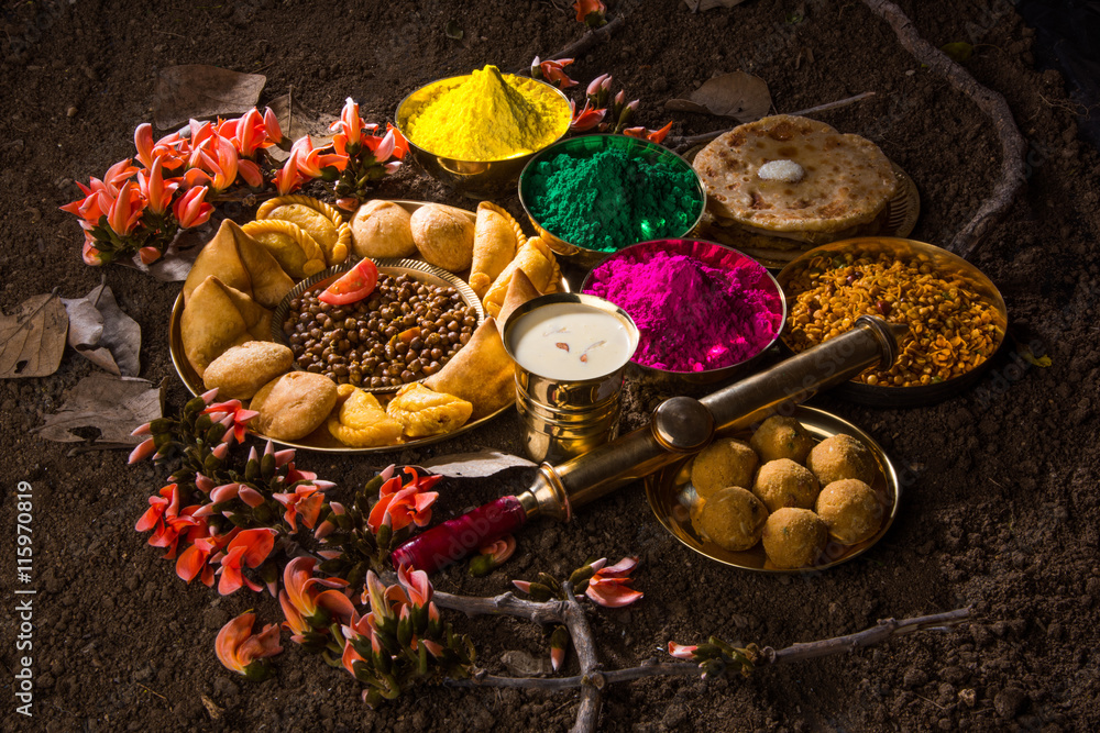 Naklejka premium holi festival food with colours, indian festival holi, samosa, kachori, laddu, gujiya, palash flower, thandai, farsan, chana masala, puran poli or roti, indian festival of colours called holi