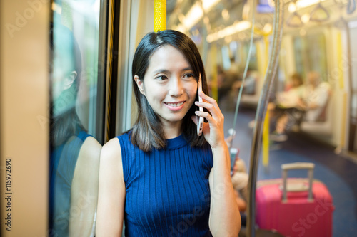 Woman talk to mobile phone on train