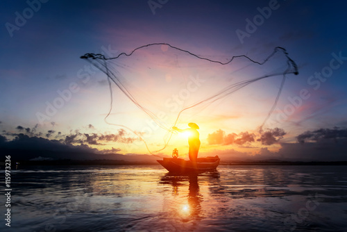Silhouettes of the traditional fishermen at the sunset near Galle in Sri Lanka.