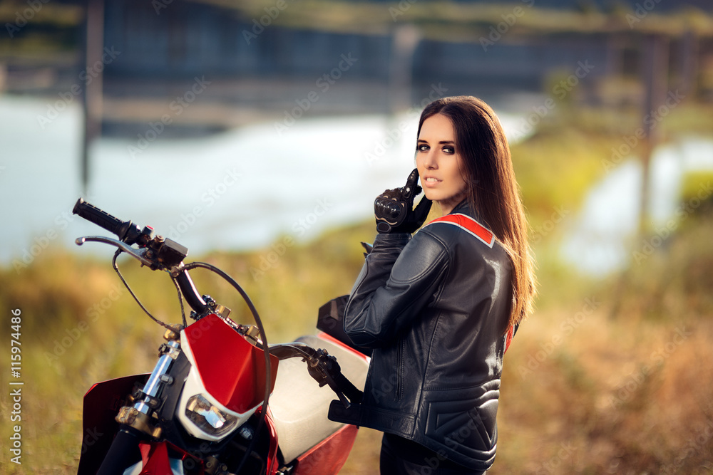 Fototapeta premium Female Motocross Racer Next to Her Motorcycle 